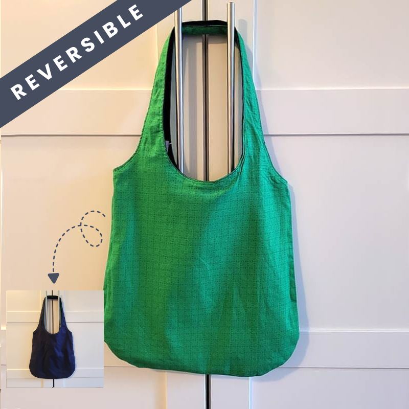 This over-the-shoulder style bag is completely reversible - with durable denim on one side and a fun, patterned pink flower fabric on the other - so you can switch up your look anytime.